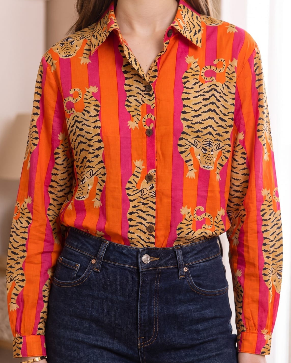 Close-up front view of the Tibetan Tiger Blouse showing the pointed collar, button placket, and tiger-and-stripe print detail in orange, pink, and black