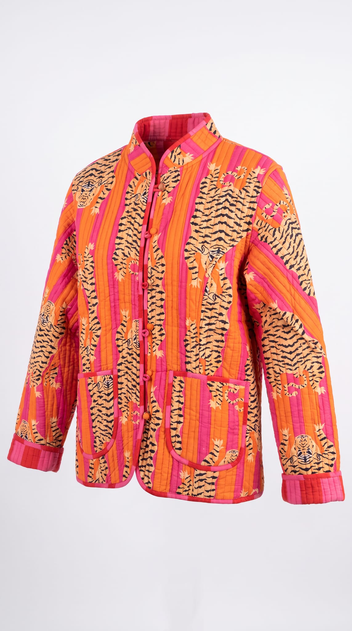 Orange Tibetan Tiger Jacket displayed flat, showing the full front tiger-stripe block print, mandarin collar, knot button closures, and patch pockets